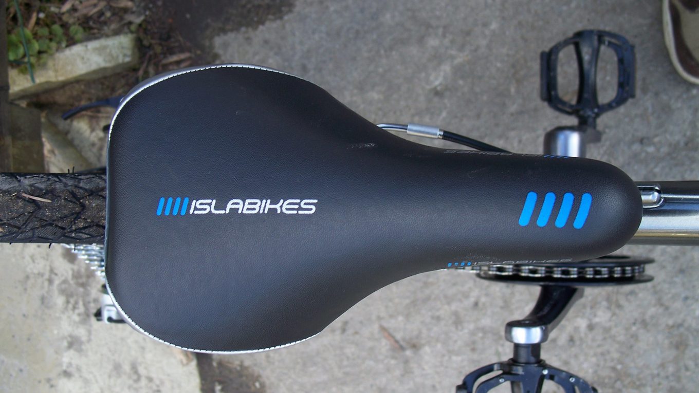 Top down view of a bicycle saddle with the brand name "Islabikes". Original Image by Dave Haygarth. CC BY 2.0 DEED (https://flic.kr/p/65zcq3)