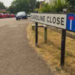 Caroline Close, Whitestone, Nuneaton - the entrance to the street showing a close-up of the road name with the street going off into the distance on the left of the image. Some cars can be seen parked up in the distance and opposite side of the road.