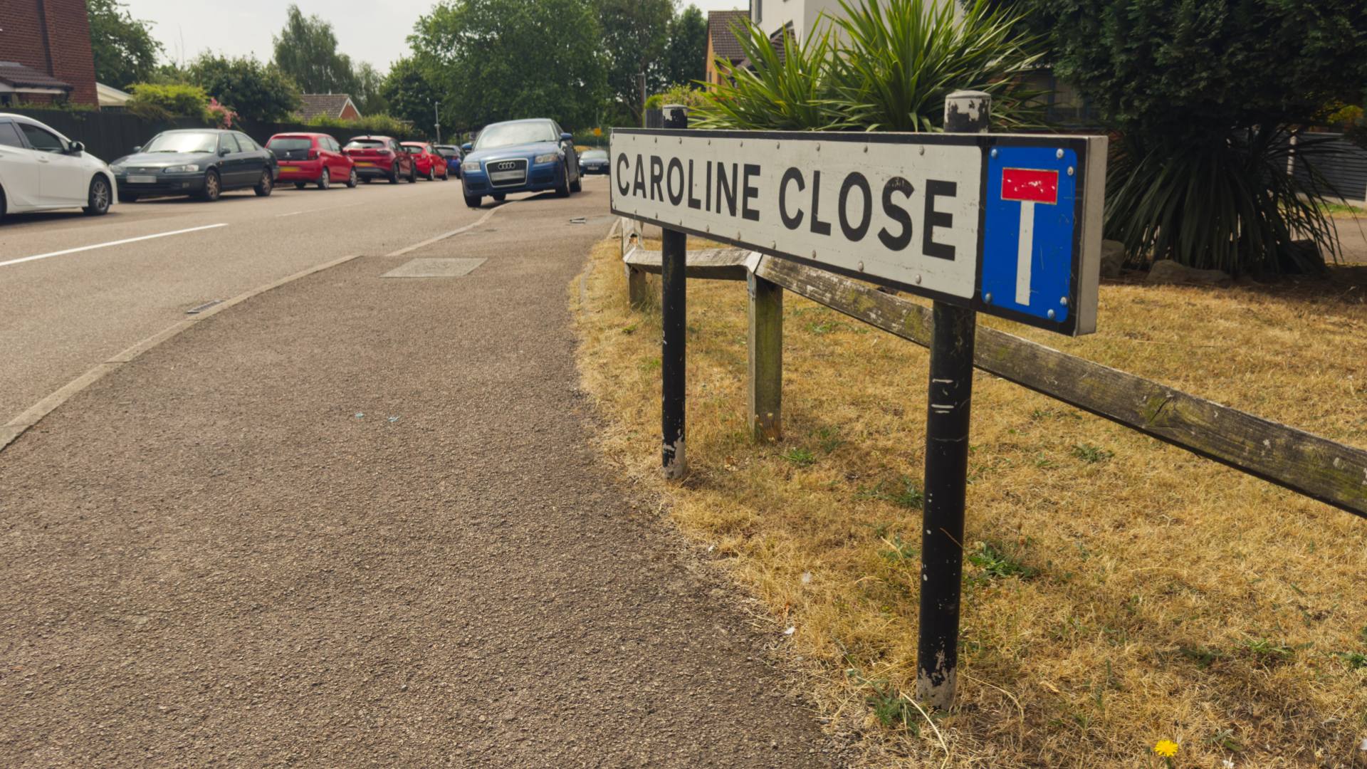 Caroline Close, Whitestone, Nuneaton - the entrance to the street showing a close-up of the road name with the street going off into the distance on the left of the image. Some cars can be seen parked up in the distance and opposite side of the road.