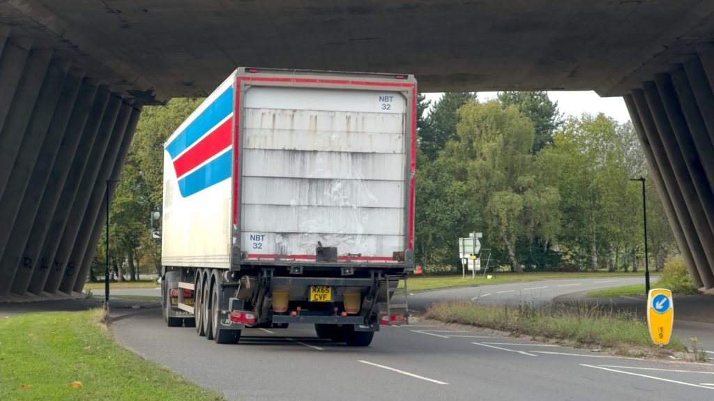 Approaching Longford Road/Wilsons Lane/Pickards Way/B4113 Roundabout between Bedworth and Coventry. The road leads away, under the M6. A lorry approaches the roundabout in the left lane of the carriageway.